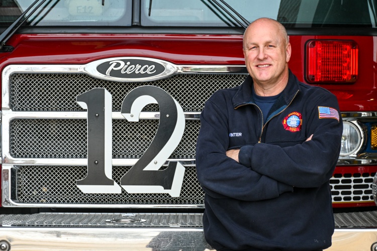 Tom Winter stands in front of Engine 12