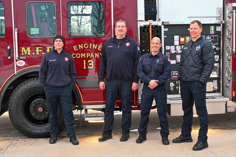 Engine 13's fire/EMS crew stands next to the fire engine