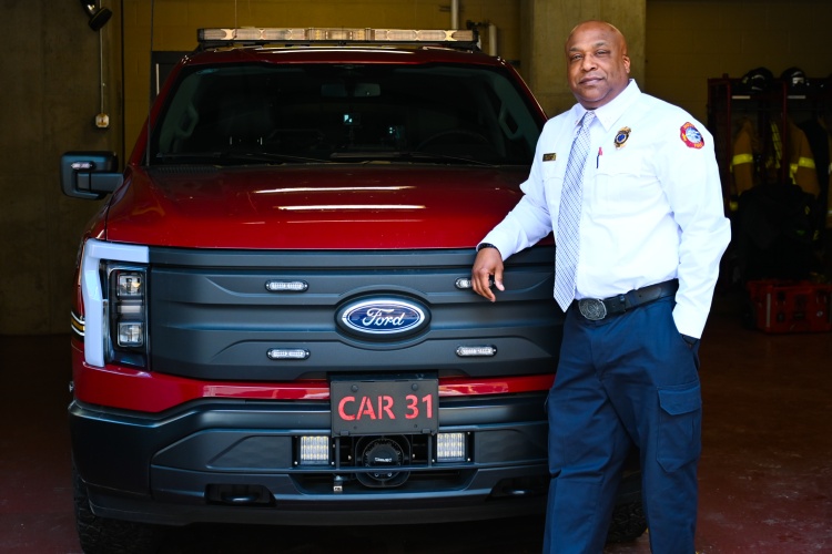 Division Chief David Bridges standing by Command Car 31