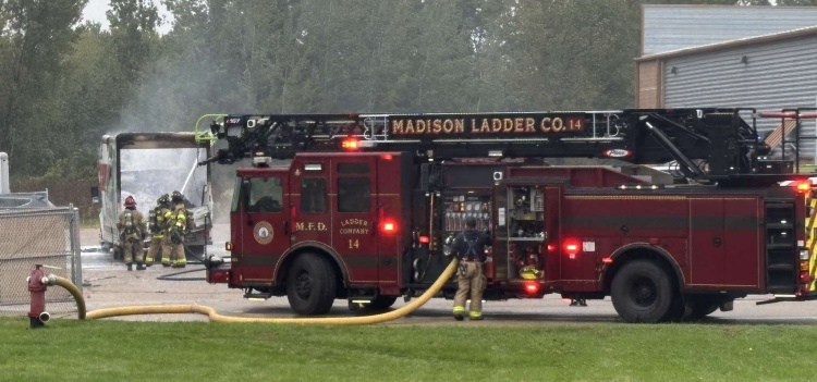 Ladder 14 feeds water to firefighters