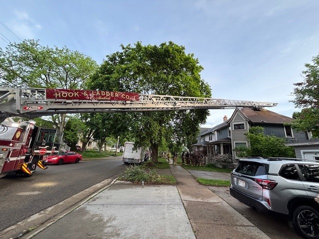 Ladder 1 extended over roof of residence