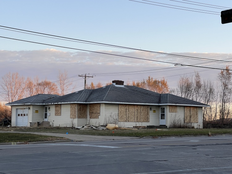 Single-story home with windows boarded up