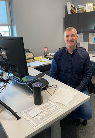 Randy Koch sitting at his desk in 2023