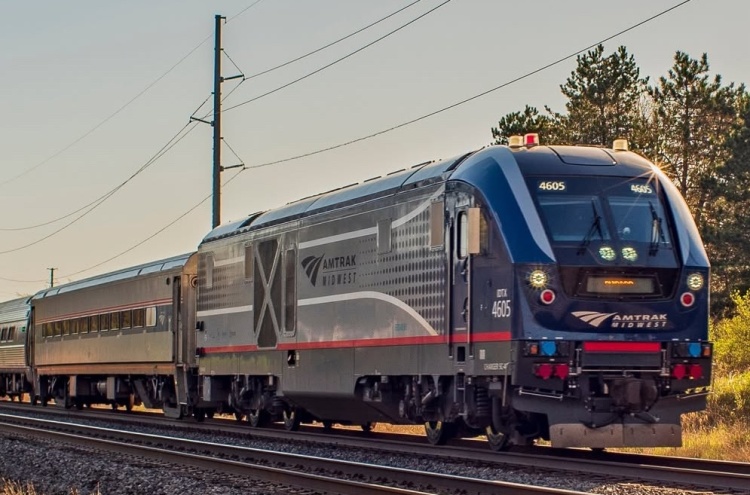 Amtrak train moving at sunset
