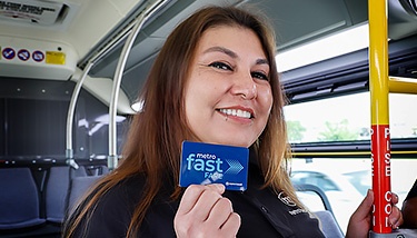 Metro driver holding a Fast Fare card