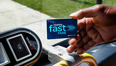 Hand holding a Fast Fare card