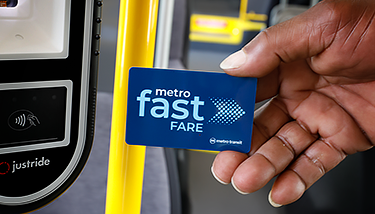 Hand holding a Fast Fare card