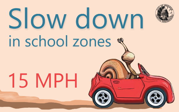 cartoon of red car being driven by a snail and the words "Slow Down in School Zones" and "15 MPH"