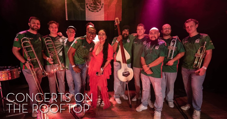 12 piece Latin band poses with their instruments