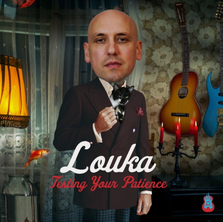A man standing with an overly large head in a living room with a guitar hanging on the wall