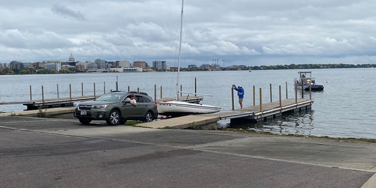 car with trailer launching a sailboat at Olin Park boat launch