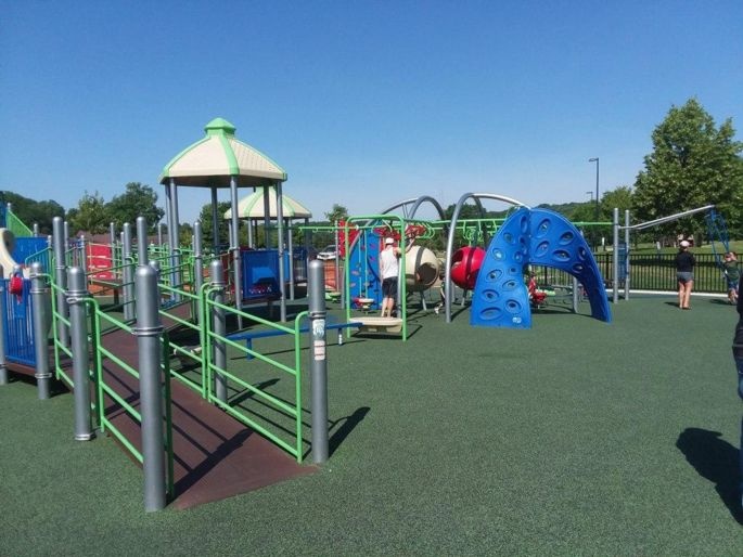 Accessible playground at Elver Park. There are ramps built into the play structure and a rubber surface on the ground.