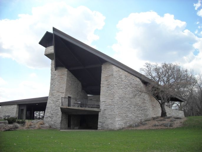 Two-level stone shelter with triangular roof.