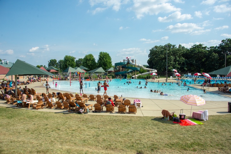 A busy day at Goodman Pool with blue sky and lots of people in and out of the water.