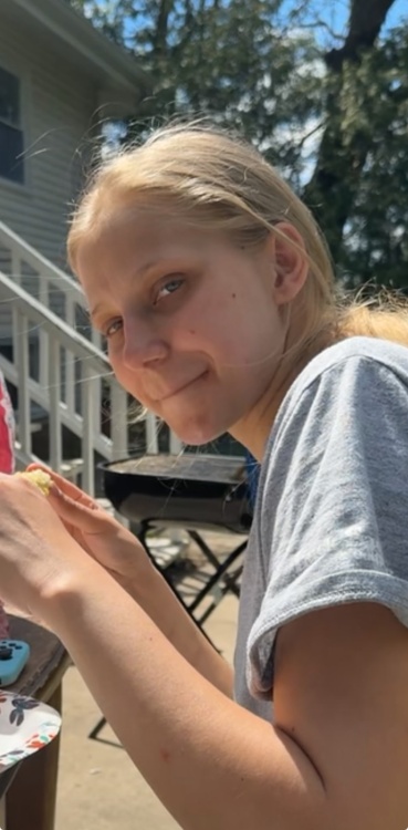 Photograph of Kathren, White female with blonde hair wearing a gray short sleeve shirt