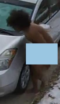 Naked suspect attempts to break into vehicle.
