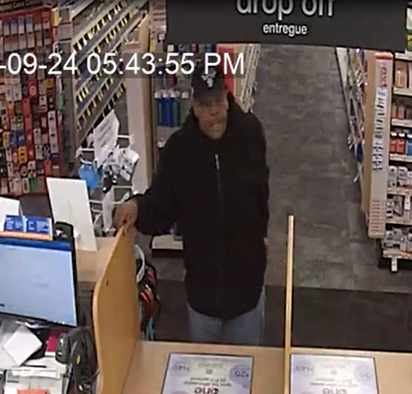 Man stands at a pharmacy counter trying to get a fraudulent prescription of 180 oxy pills filled.