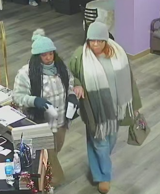 Women wearing long-sleeved shirts and hats believed to be suspects in a theft case.