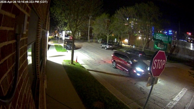 Surveillance video image showing a red or maroon minivan that was involved in a hit-and-run crash that injured a cyclist. 