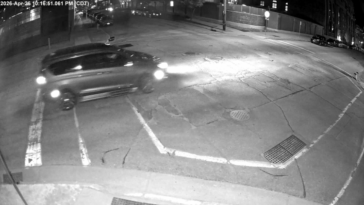 Surveillance video image showing a red or maroon minivan that was involved in a hit-and-run crash that injured a cyclist. 