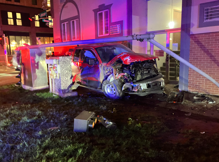 Driver arrested for OWI after a red truck crashes into a building.