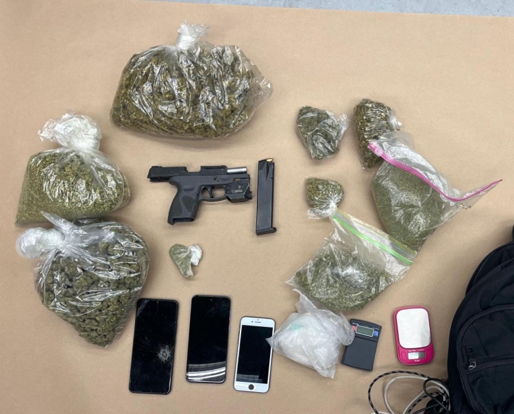 Loaded gun, drugs, phones and cash on a table after being recovered during a traffic stop.