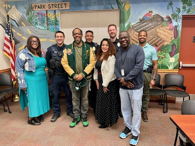 Members of the Community Policing Advisory Boards stand in the South District Police Station.
