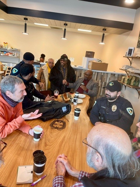 Members of the Community Policing Advisory Boards talk to officers over a cup of coffee.