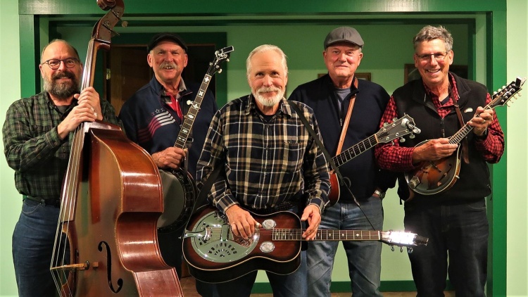 The five men who make up the Soundbillies. Each person is holding an instrument that they play.
