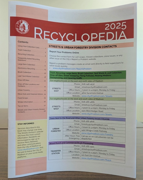 A paper copy of the 2025 Recyclopedia standing up on a table.