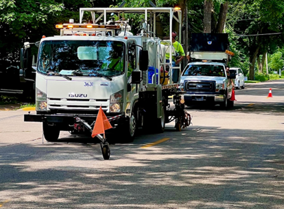 front of the specialized paint truck that paints the lane line on the roadway.