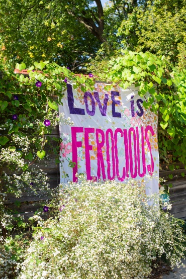 Artistic banner that says "love is ferocious"
