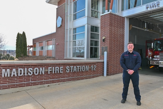 Firefighter/EMT Dillon Rickaby in front of Fire Station 12