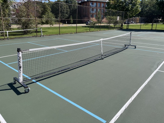 Portable pickleball net at Olbrich Park tennis/pickleball court.