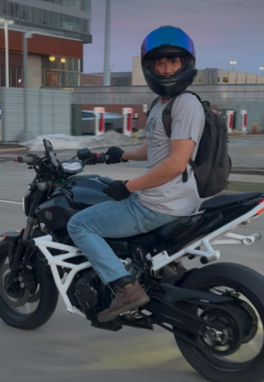 Motorcycle rider wearing a blue helmet. 
