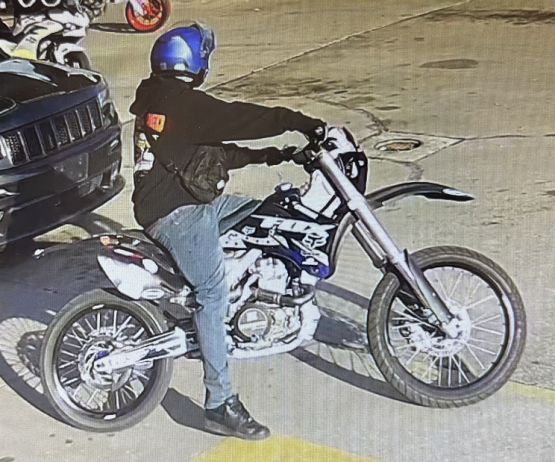 Motorcycle rider wearing a black sweatshirt and blue helmet.