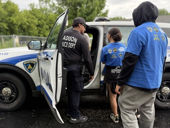Two middle school students learn about policing and traffic stops during the Black Youth Academy