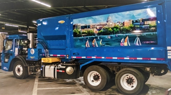 A mural of the Madison skyline painted on a collection truck