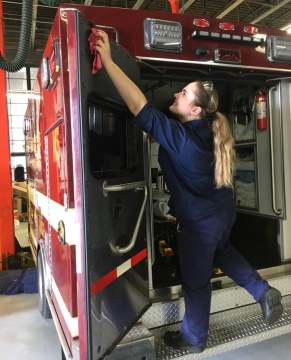 High school apprentice works on ambulance