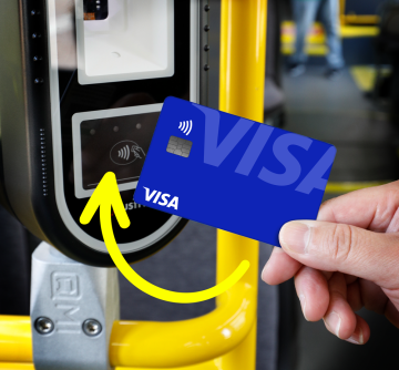 Passenger tapping a credit card on the bus fare reader.