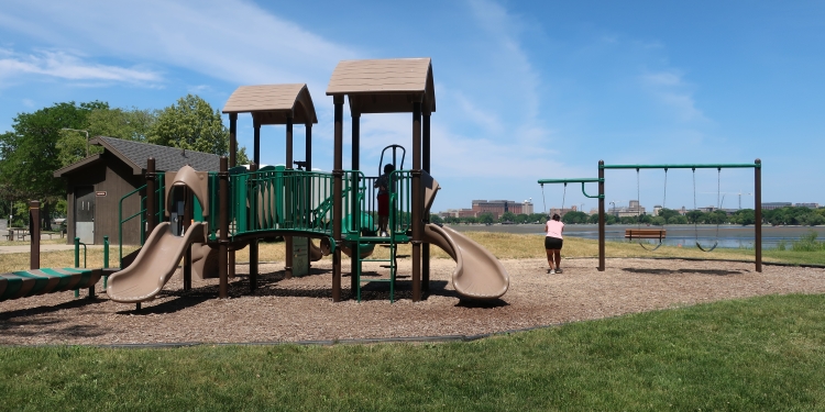 playground with family and lake in background