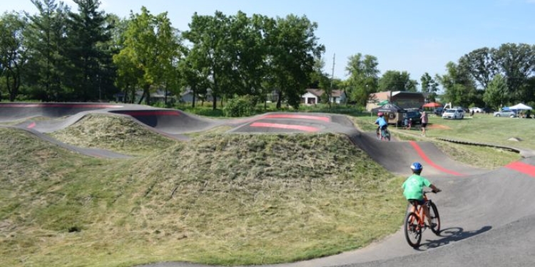 People biking on the pump track