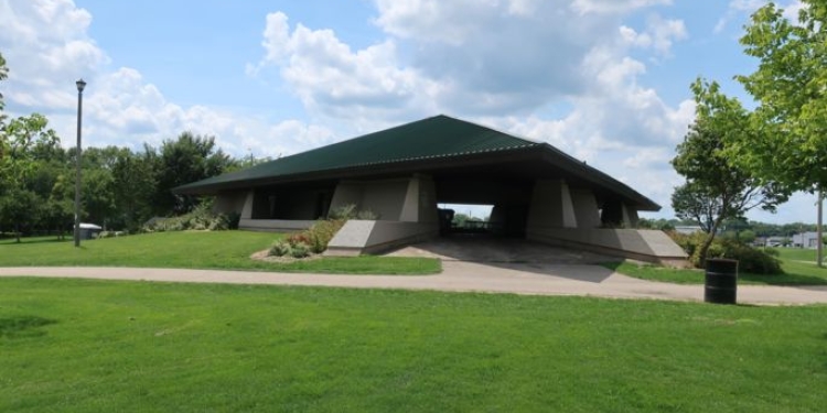 Park shelter with grassy area and path.