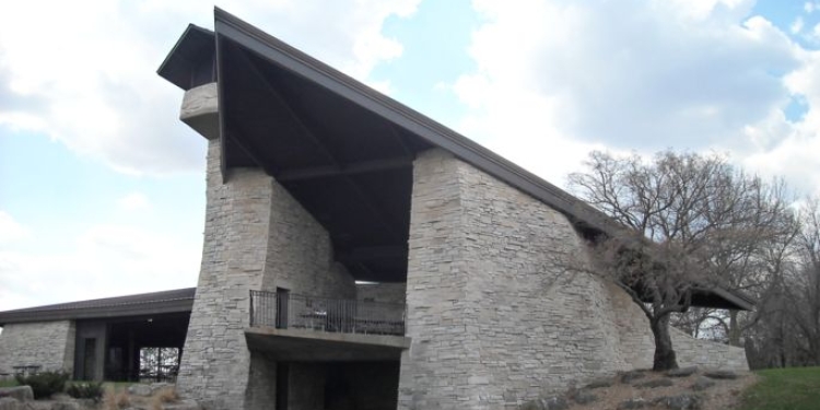 Two-level stone shelter with triangular roof.