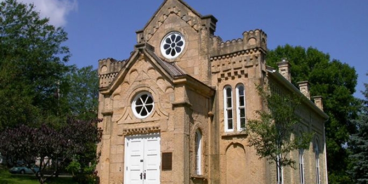 Synagogue building surrounded by trees. 