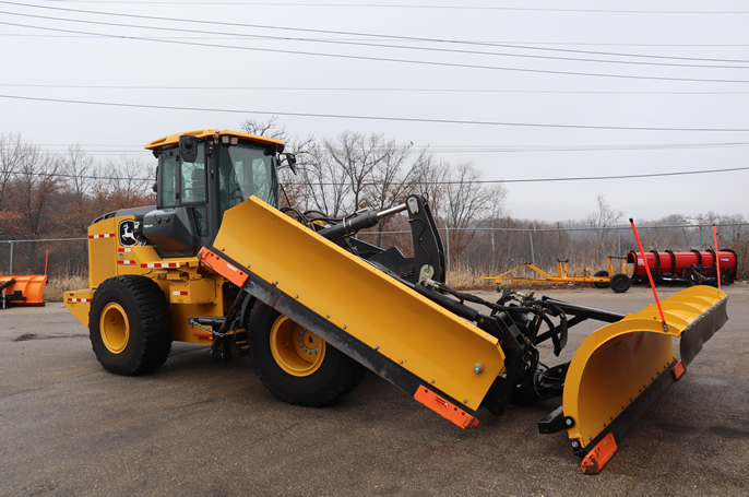 Loader with a plow and a wing attachment