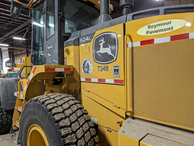 The loader with plow and a wing with the Seymour Pavement name badge