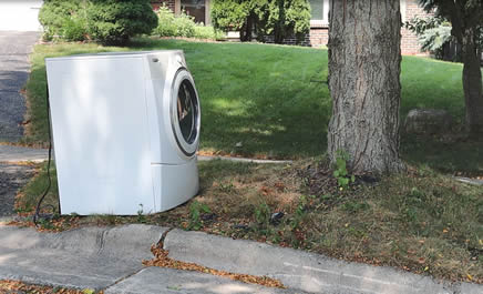 This washer should have an appliance sticker. And it's too close to the tree.